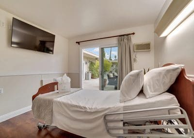 Bedroom with single bed and TV